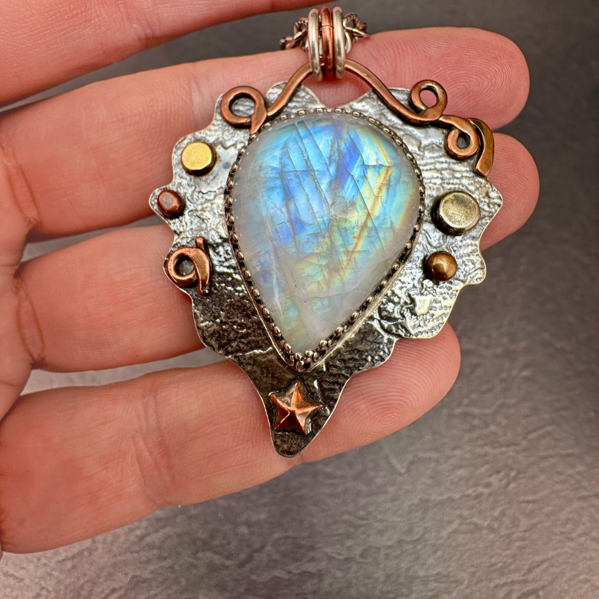 Rainbow Moonstone Heart Necklace in hand