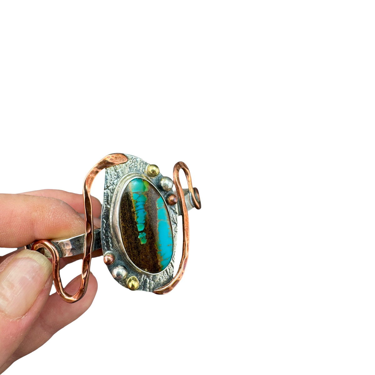 Opalized wood cuff bracelet held in hand