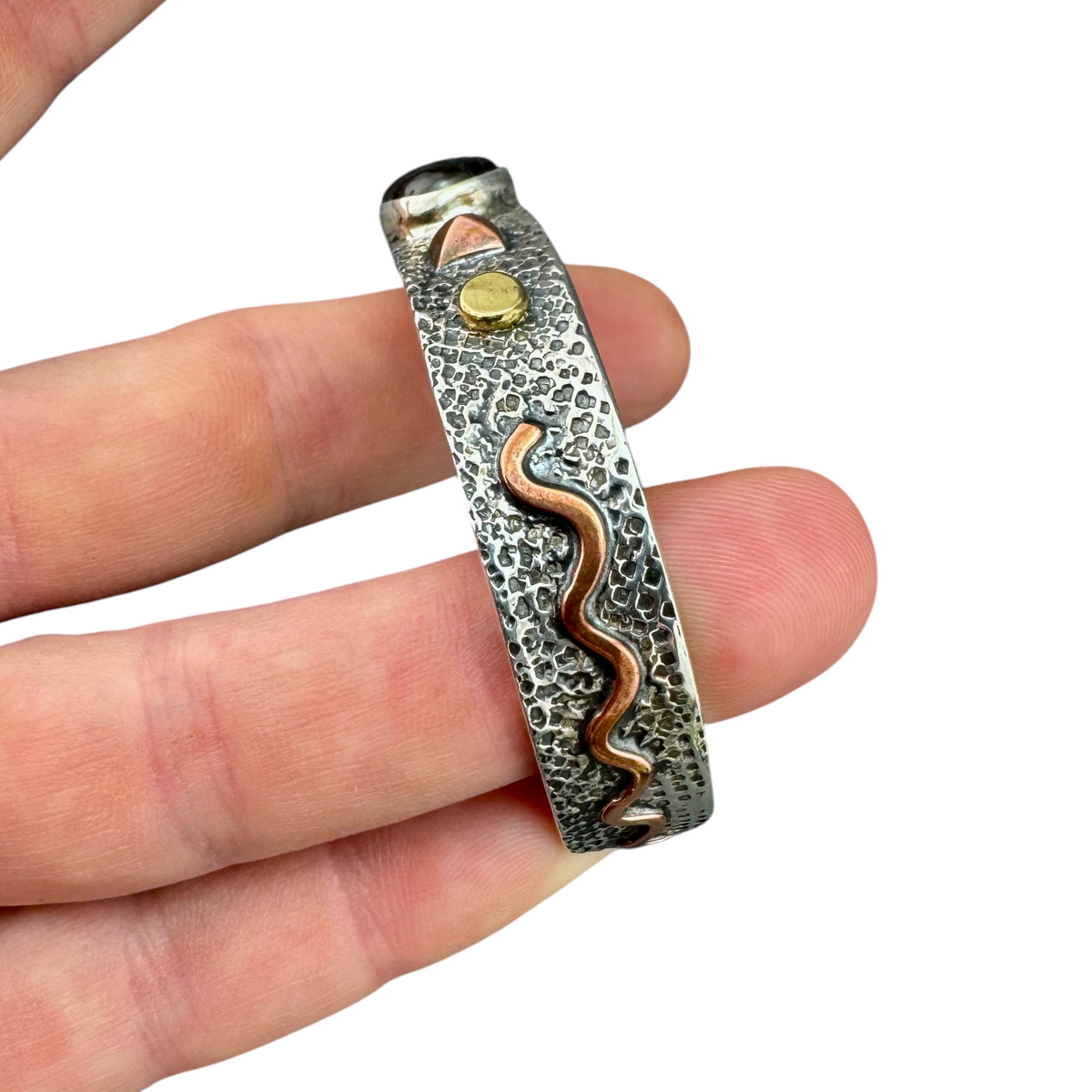 Side view of the Aurora Labradorite cuff showing the wavy copper detail