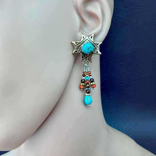 Kingman Turquoise Star Earring shown on the ear, Ancient Bronze star with gemstone dangles