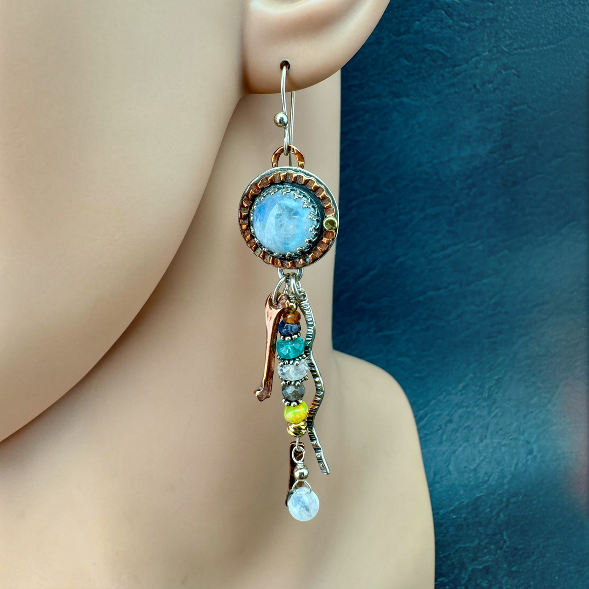 Moonstone Waterfall Dangle Earrings shown on the ear, rainbow moonstone with cascading gemstone and metal dangles