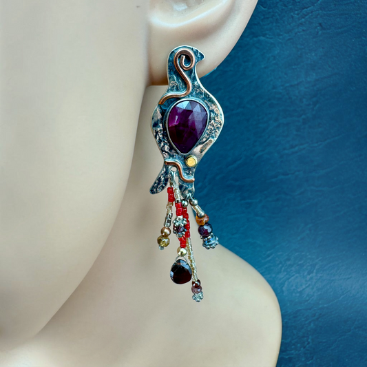 Ruby Quail Earring shown on the ear, textured sterling silver quail with rosecut ruby and beaded feathers