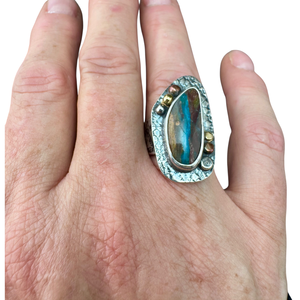 Opalized wood ring worn on the hand