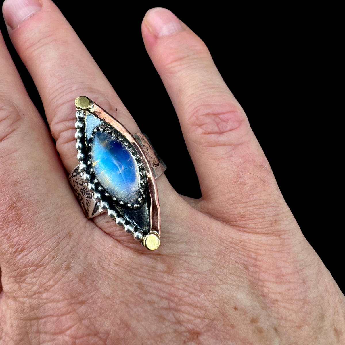Rainbow Moonstone marquise ring worn on the hand