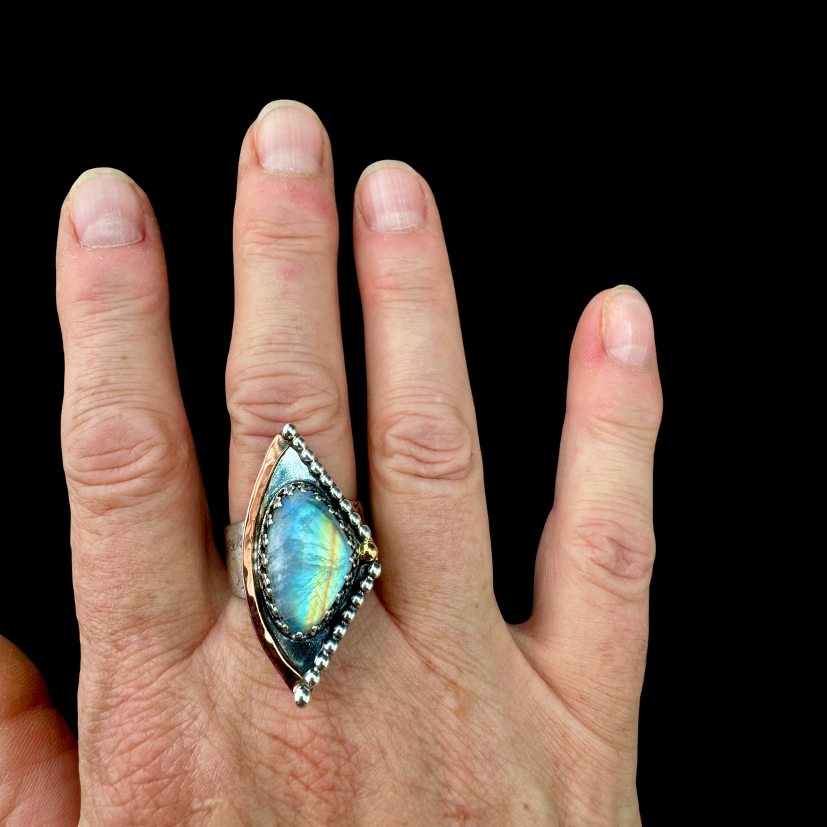 Rainbow Moonstone Satellite ring worn on the hand
