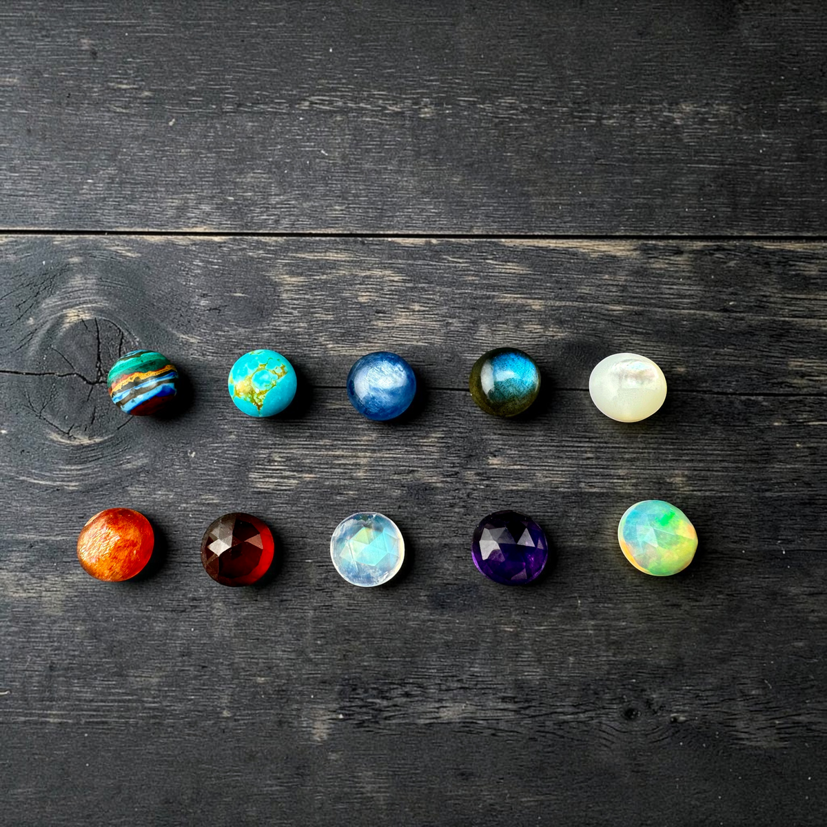Stone options for Orbit Necklace, left to right top to bottom: Rainbow Calsilica, Turquoise, Kyanite, Labradorite, Mother of Pearl, Sunstone, Rosecut Garnet, Rosecut Rainbow Moonstone, Rosecut Amethyst, Rosecut Ethiopian Opal